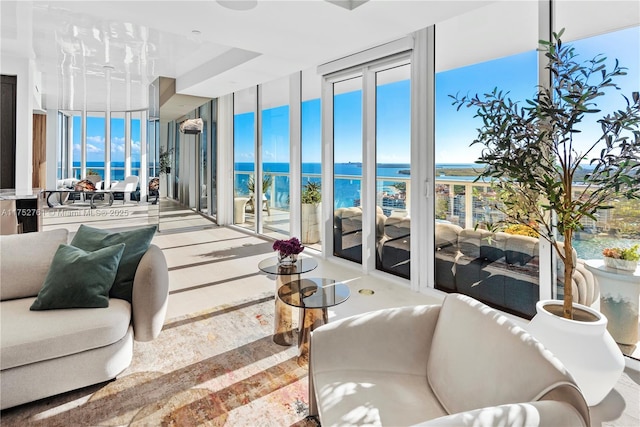 living area featuring expansive windows and a water view