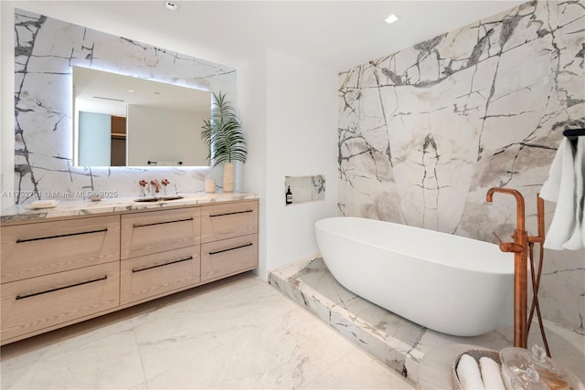 bathroom with marble finish floor, stone wall, and vanity