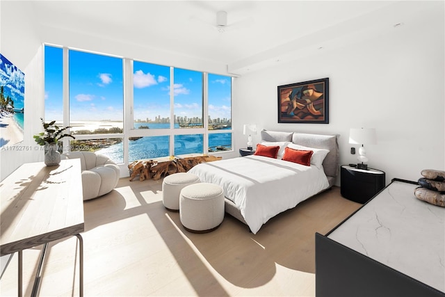 100 S Pointe Dr Unit 2803, Miami Beach, FL 33139 - bedroom featuring a water view, wood finished floors, and a wall of windows