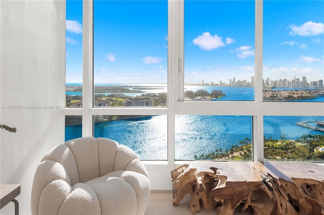 sunroom / solarium featuring a city view and a water view