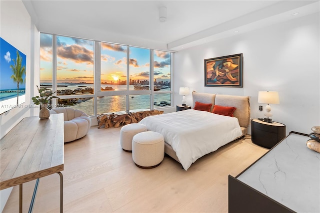 100 S Pointe Dr Unit 2803, Miami Beach, FL 33139 - bedroom featuring a water view, wood finished floors, recessed lighting, and a wall of windows
