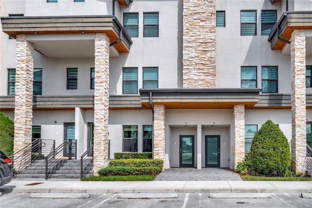 exterior space featuring uncovered parking and stucco siding