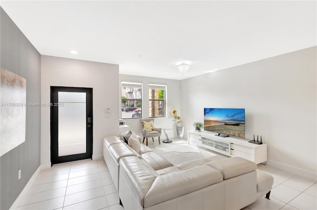 living room featuring light tile patterned floors and baseboards