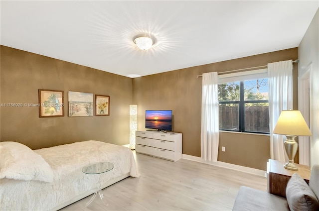 bedroom featuring wood finished floors and baseboards