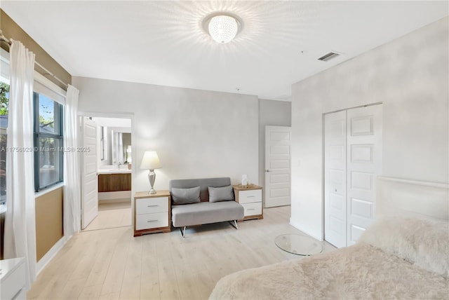 bedroom featuring visible vents, baseboards, and wood finished floors