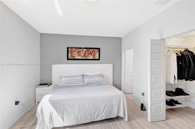 bedroom with light wood-style flooring and baseboards