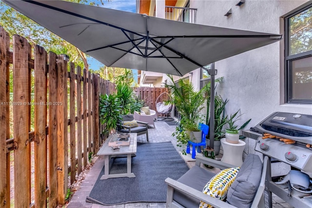 view of patio / terrace featuring area for grilling and fence