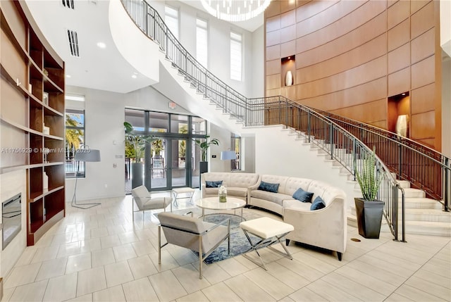 living room with visible vents, stairway, tile patterned flooring, a high ceiling, and french doors