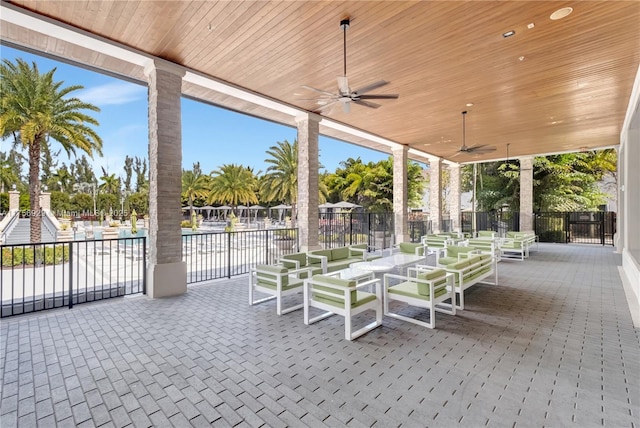 view of patio with a ceiling fan and fence