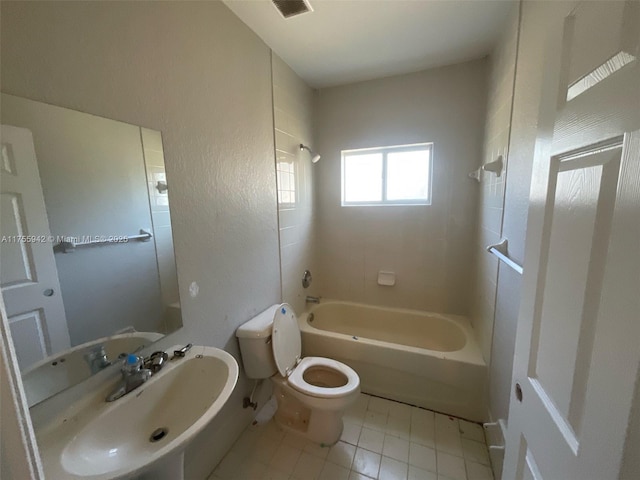 bathroom featuring washtub / shower combination, visible vents, a sink, and toilet