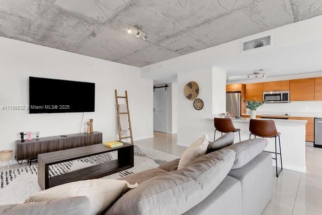 living area with visible vents and a barn door