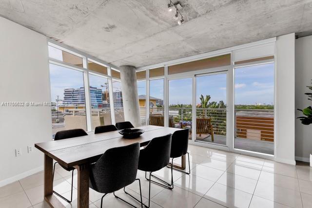 dining room featuring a wealth of natural light, baseboards, and expansive windows