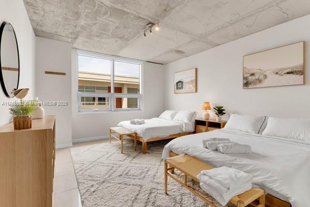 bedroom with baseboards and track lighting