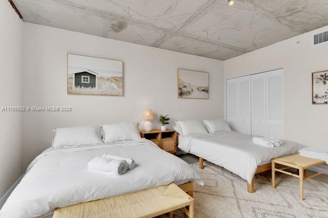 bedroom featuring a closet and visible vents