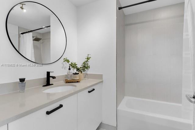 bathroom featuring shower / tub combo with curtain and vanity