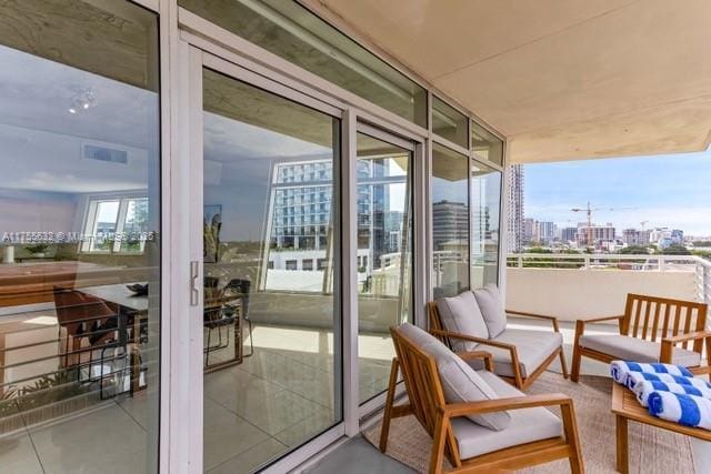 balcony featuring a city view and visible vents
