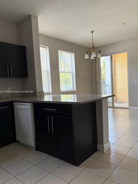 2111 Shoma Dr Unit 2111, Royal Palm Beach, FL 33414 - kitchen featuring dishwasher, dark cabinetry, a chandelier, and a peninsula