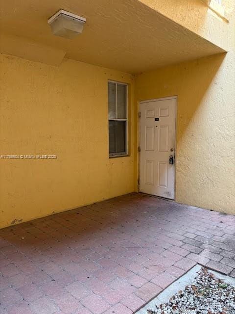 2111 Shoma Dr Unit 2111, Royal Palm Beach, FL 33414 - entrance to property with stucco siding and a patio