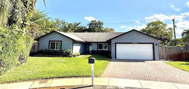 single story home with decorative driveway, stucco siding, an attached garage, fence, and a front lawn