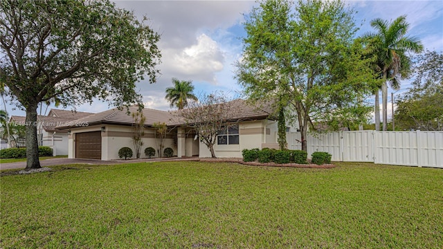 ranch-style home featuring a front yard, fence, a tiled roof, and an attached garage