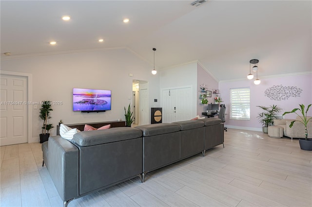 living area with ornamental molding, light wood-style floors, and vaulted ceiling