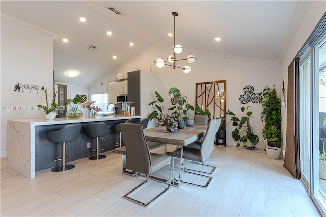 dining area with vaulted ceiling, ornamental molding, visible vents, and a notable chandelier