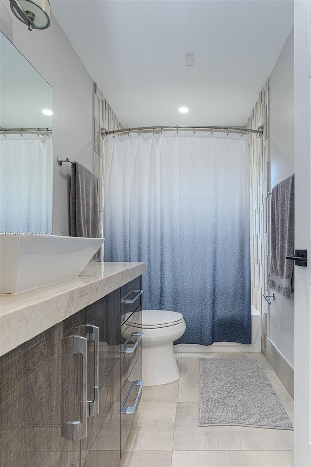 full bath with tile patterned flooring, vanity, toilet, and shower / tub combo with curtain