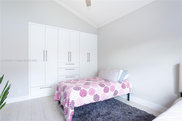 bedroom with lofted ceiling, wood finished floors, a ceiling fan, baseboards, and ornamental molding