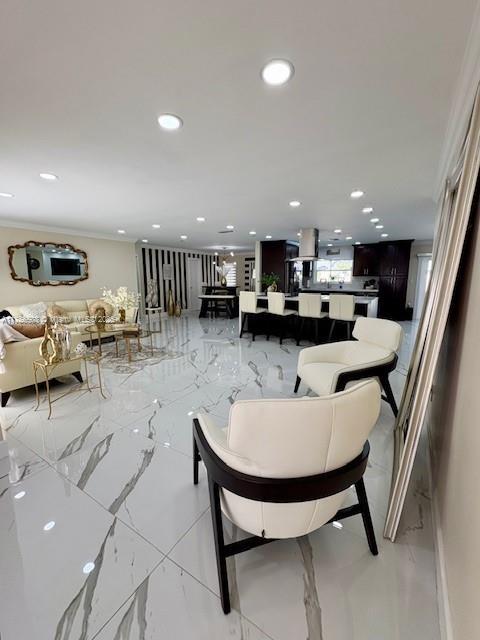 living room with recessed lighting, marble finish floor, and crown molding