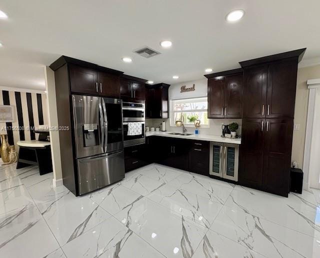 kitchen featuring marble finish floor, visible vents, stainless steel appliances, and a sink