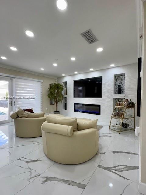 living area featuring recessed lighting, a glass covered fireplace, visible vents, and crown molding