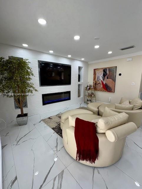 living area with visible vents, a glass covered fireplace, marble finish floor, crown molding, and recessed lighting