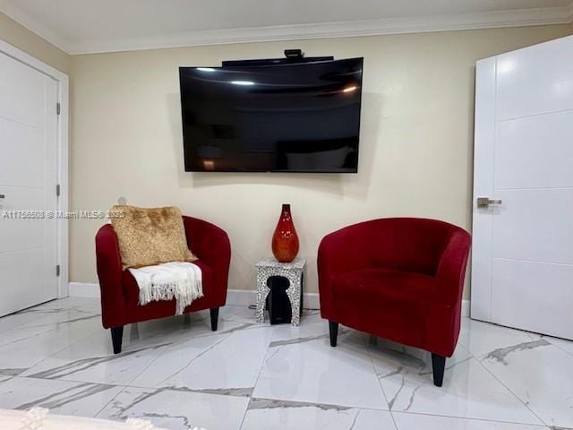 living area with marble finish floor, baseboards, and ornamental molding