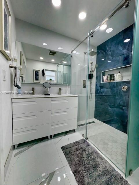 full bath with visible vents, a stall shower, vanity, and recessed lighting