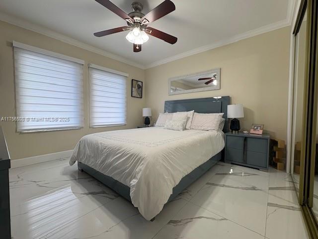 bedroom featuring marble finish floor, baseboards, ornamental molding, and a ceiling fan