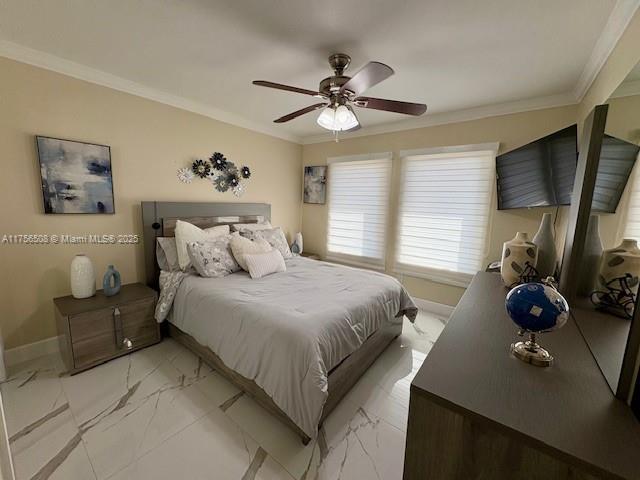 bedroom with ornamental molding, marble finish floor, baseboards, and a ceiling fan