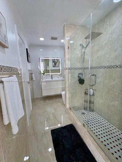 bathroom featuring visible vents, toilet, a stall shower, and vanity