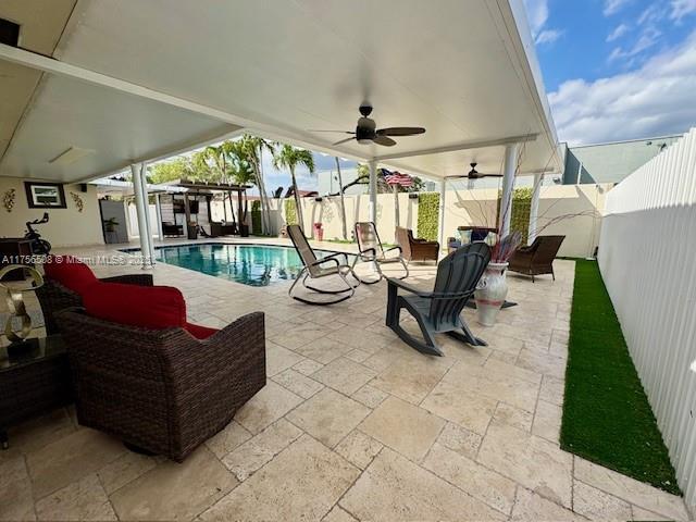 view of patio featuring a fenced backyard, a ceiling fan, and a fenced in pool