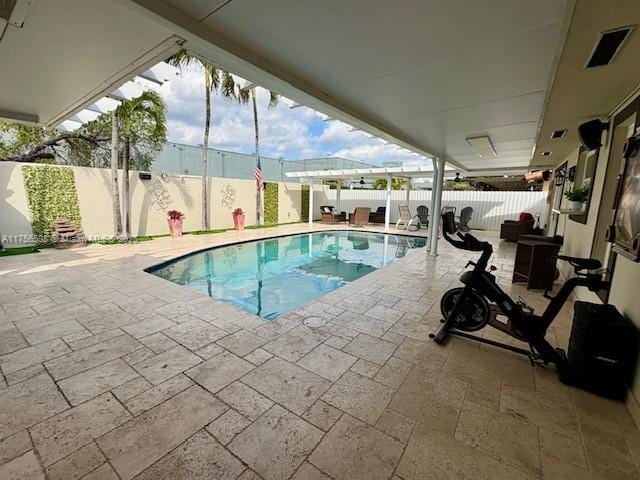 view of swimming pool with a fenced in pool, a fenced backyard, and a patio