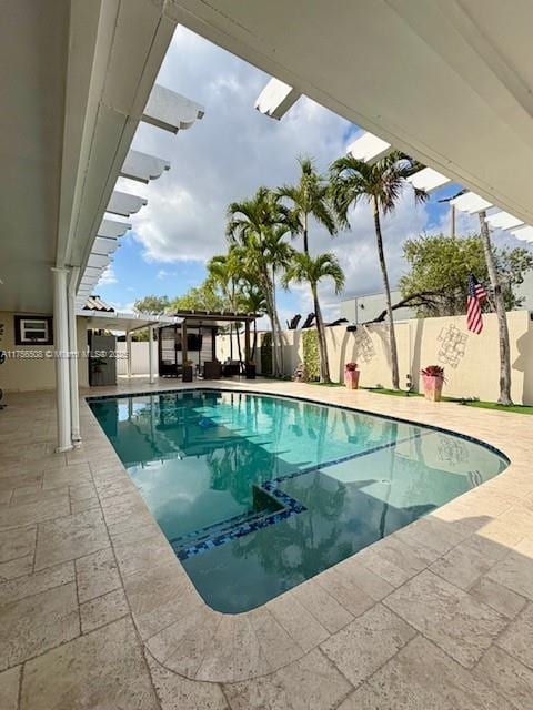 view of pool with a patio, a fenced backyard, a fenced in pool, and a pergola