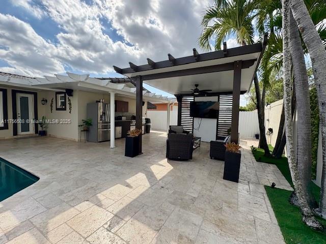 view of patio / terrace with a fenced backyard, ceiling fan, a fenced in pool, and area for grilling