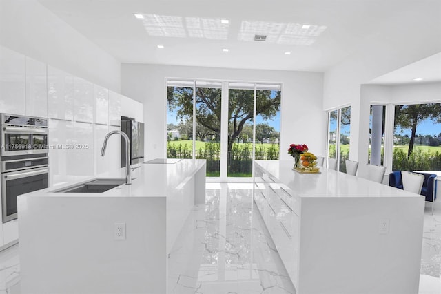 2578 NW 63rd Ln, Boca Raton, FL 33496 - kitchen with a spacious island, modern cabinets, and a sink