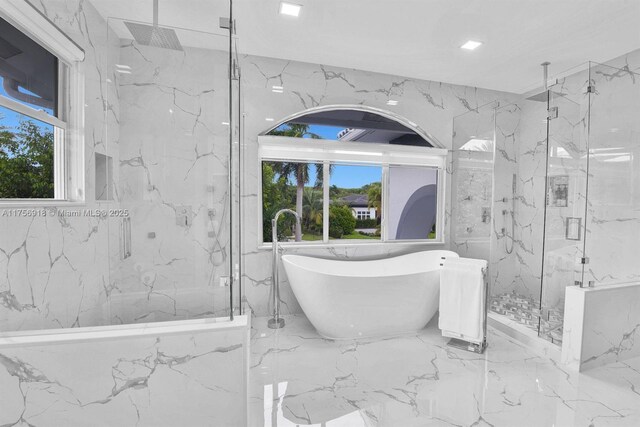 2578 NW 63rd Ln, Boca Raton, FL 33496 - bathroom featuring marble finish floor, a freestanding tub, a marble finish shower, and stone wall