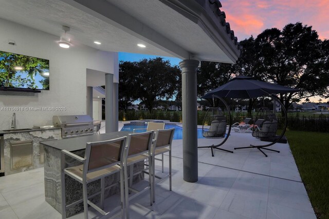 2578 NW 63rd Ln, Boca Raton, FL 33496 - patio terrace at dusk featuring a fenced in pool, grilling area, exterior kitchen, outdoor wet bar, and a sink