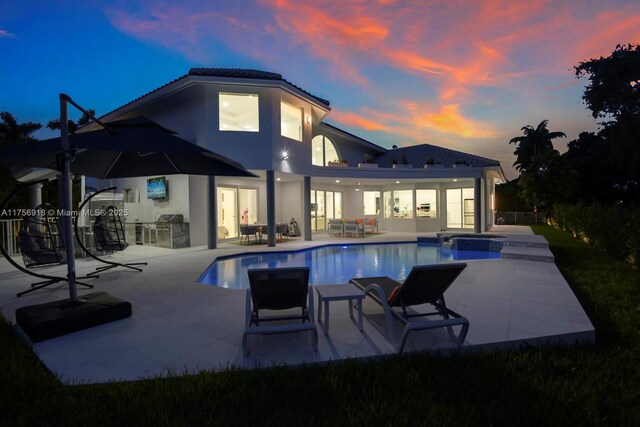 2578 NW 63rd Ln, Boca Raton, FL 33496 - view of pool with a pool with connected hot tub, a patio area, an outdoor kitchen, and an outdoor hangout area