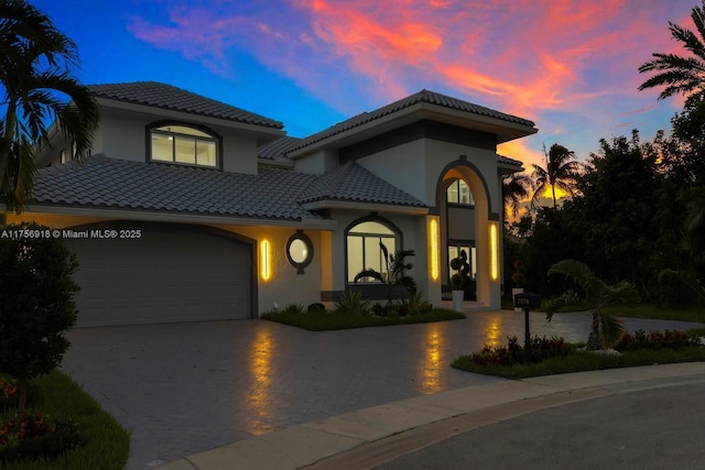 2578 NW 63rd Ln, Boca Raton, FL 33496 - mediterranean / spanish-style home featuring decorative driveway, a tile roof, and stucco siding