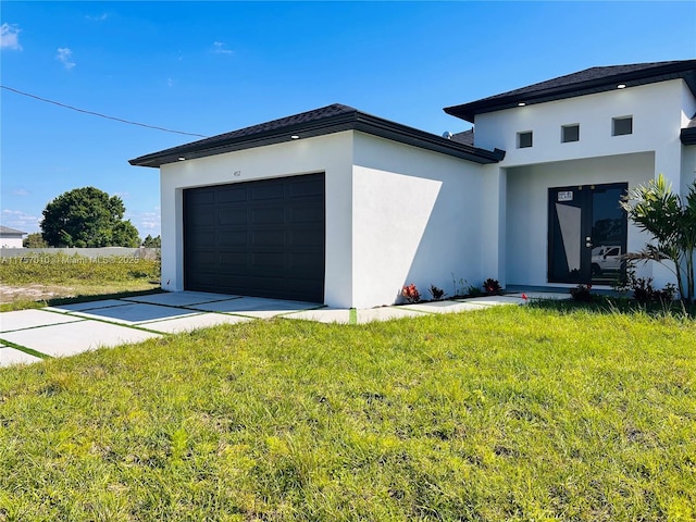 view of front facade featuring a front yard, concrete driveway, an attached garage, and stucco siding