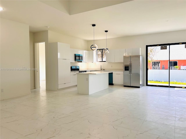 kitchen with appliances with stainless steel finishes, a kitchen island, a sink, and modern cabinets