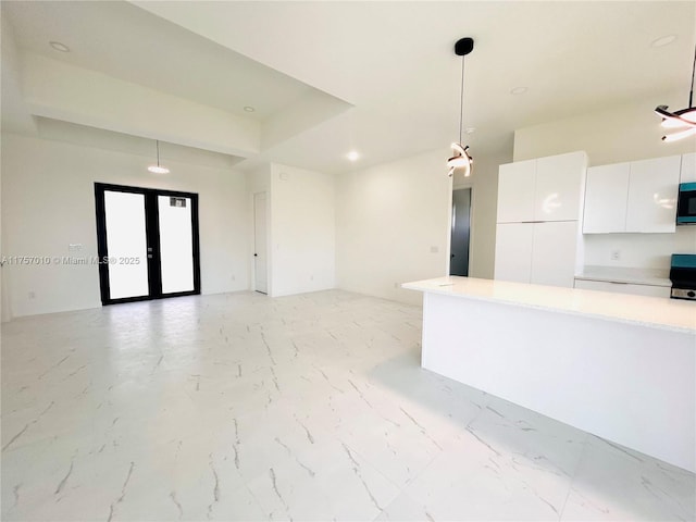 kitchen with marble finish floor, white cabinets, light countertops, and french doors