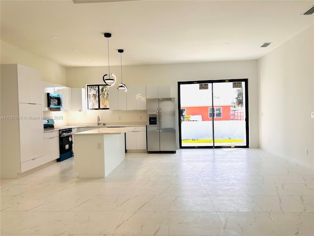 kitchen with marble finish floor, stainless steel appliances, modern cabinets, and a kitchen island